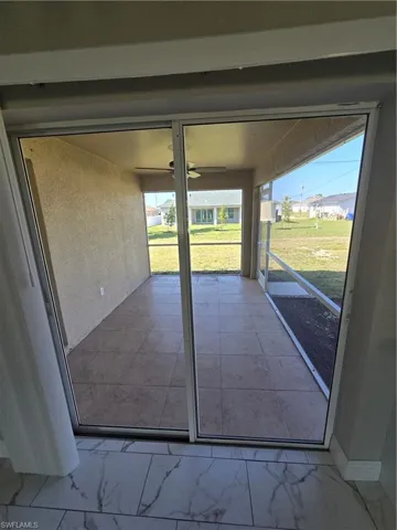 Unfurnished sunroom with ceiling fan