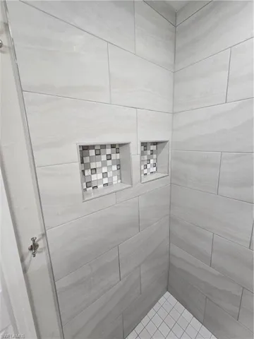 Bathroom featuring tiled shower