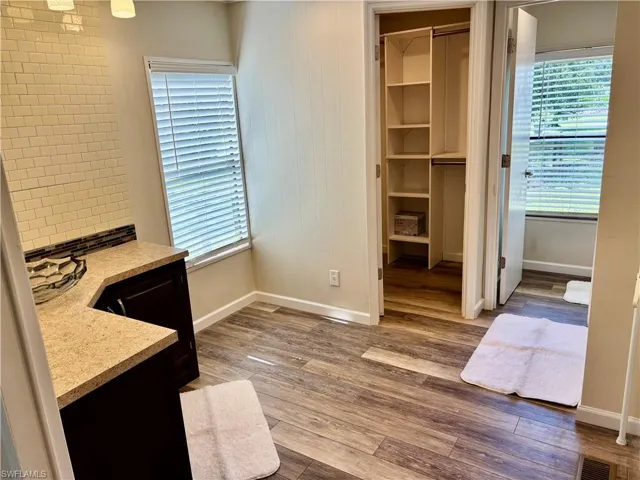 Primary bathroom With two closets and walkin shower.