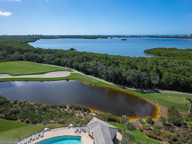 View from screened Lanai of a golf course and a nearby body of water