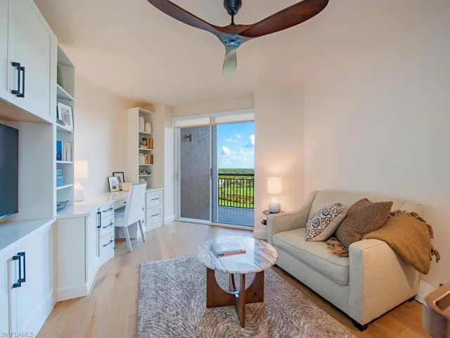 Bedroom being used as a study, access to exterior, a ceiling fan, and Oak Floors