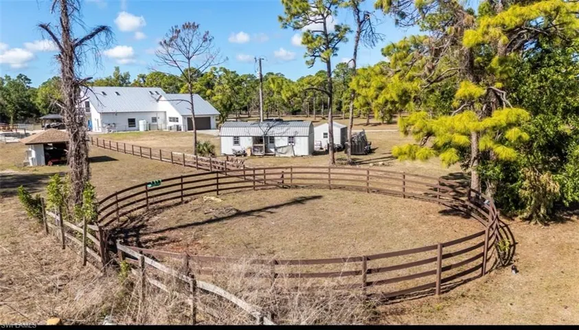 View of yard featuring an outbuilding, a garage, view of scattered trees, and a view of rural / pastoral area