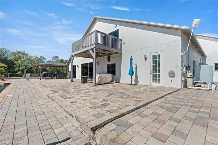 Back of property featuring a patio area, stucco siding, a deck, and a gazebo