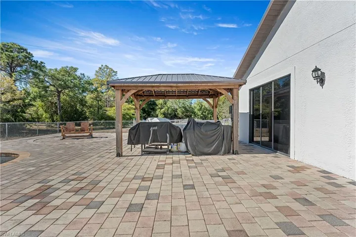 View of patio featuring a gazebo and a grill