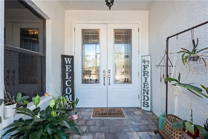 Entrance to property with french doors and stucco siding