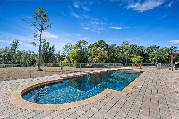 View of pool with a fenced backyard, a gazebo, and a patio