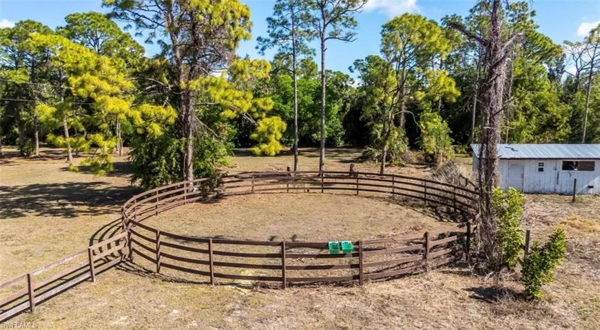 View of yard featuring an outbuilding and an enclosed riding area