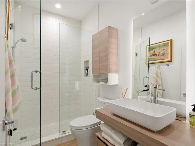 Bathroom with vanity, a stall shower, and recessed lighting