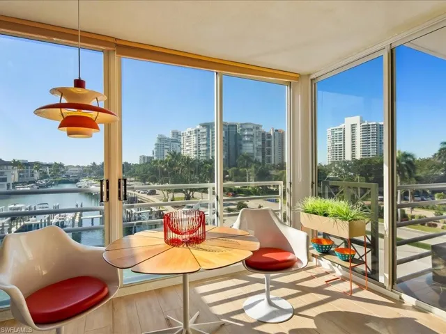 Sunroom with a view of city and a water view