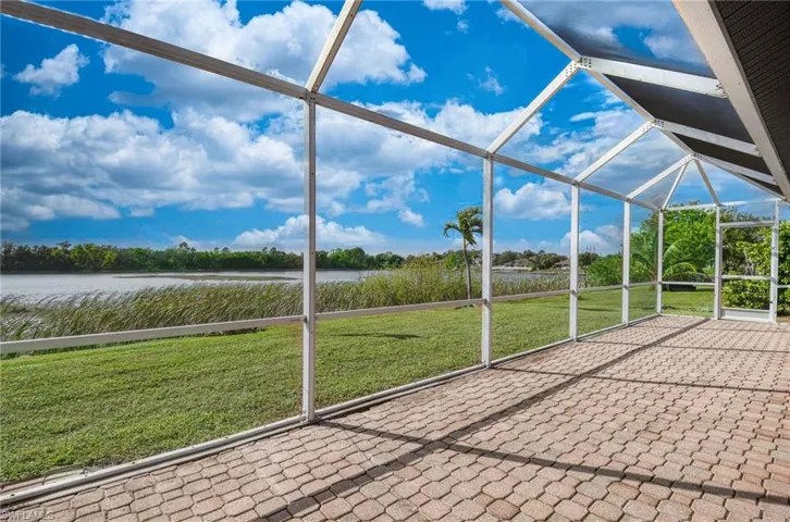 Unfurnished sunroom featuring a water view