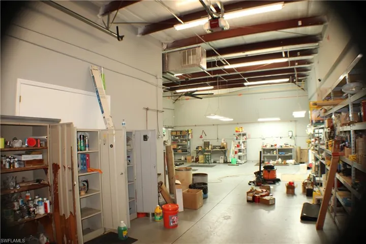 Garage featuring a workshop area and a garage door opener