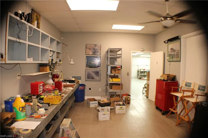 Office room featuring ceiling fan, a paneled ceiling, and tile patterned floors