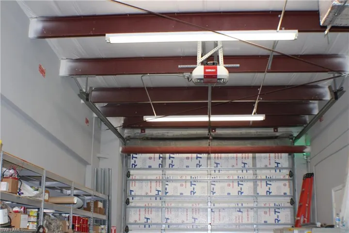 Garage featuring a garage door opener