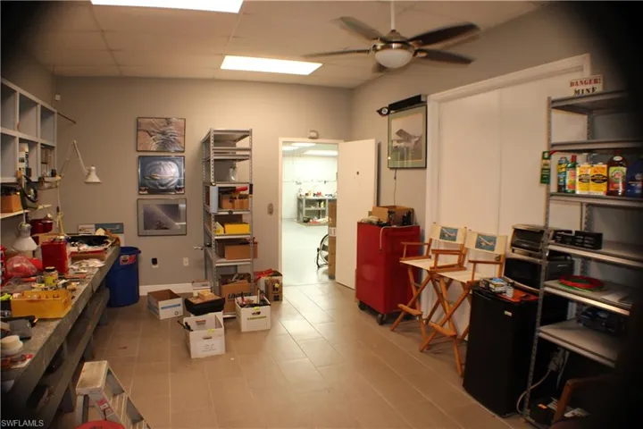 Tiled office with a paneled ceiling and ceiling fan