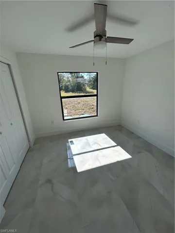 Unfurnished bedroom featuring ceiling fan and a closet