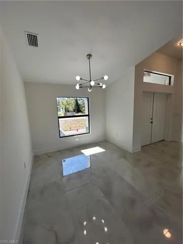 Unfurnished dining area with an inviting chandelier