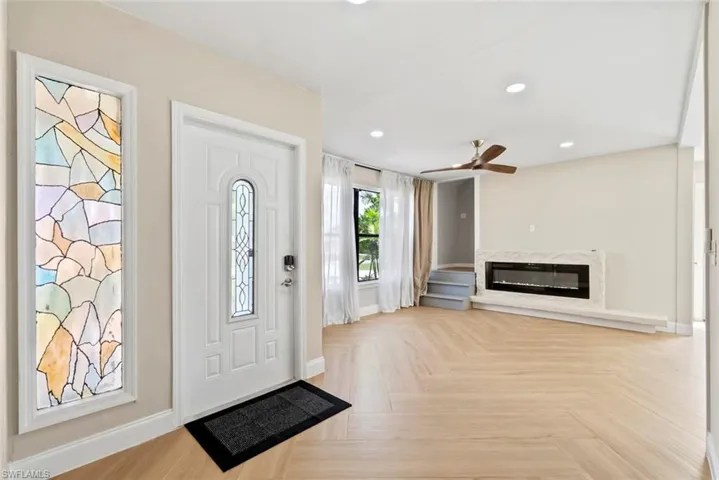 White paneled entry door with decorative glass insert