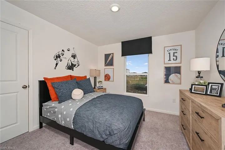 Photos are of a model home or artist rendering. Home may be virtually staged; Bedroom featuring a textured ceiling and light colored carpet