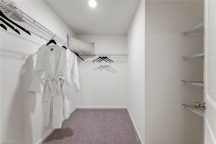 Photos are of a model home or artist rendering. Home may be virtually staged; Spacious closet with carpet flooring