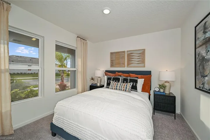 Photos are of a model home or artist rendering. Home may be virtually staged; Carpeted bedroom with a textured ceiling