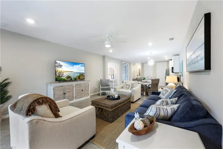 Living room with a ceiling fan, recessed lighting, and a chandelier