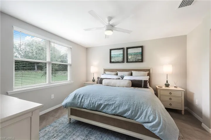 Bedroom featuring ceiling fan and baseboards