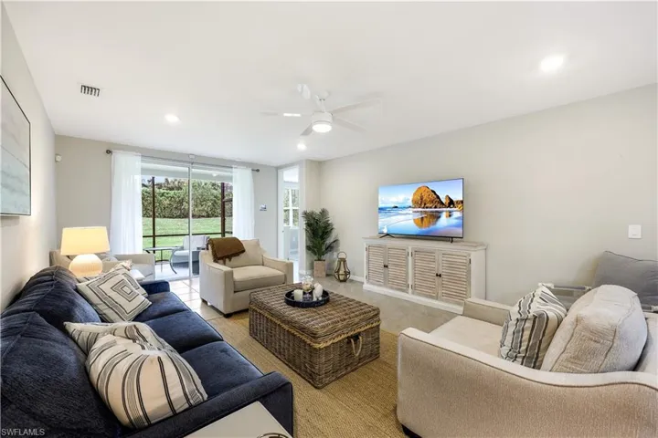 Living area with recessed lighting and a ceiling fan