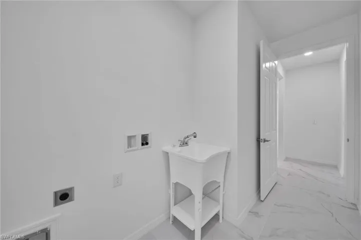 Laundry room with hookup for a washing machine, light marble finish flooring, and electric dryer hookup