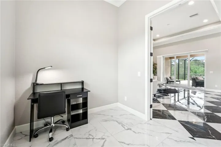 Room with white marble-look flooring, light gray walls, and white baseboards