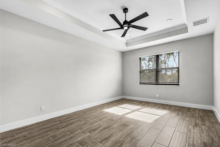Unfurnished room featuring ornamental molding, wood finish floors, and a ceiling fan