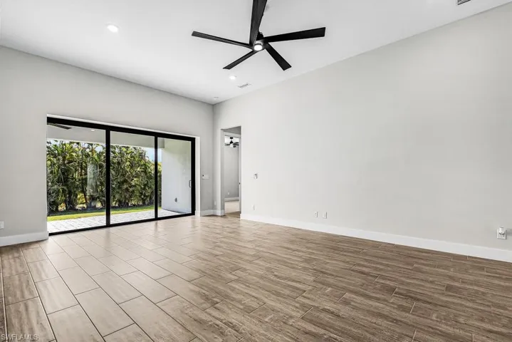 Living room featuring a ceiling fan, wood finish floors, and recessed lighting