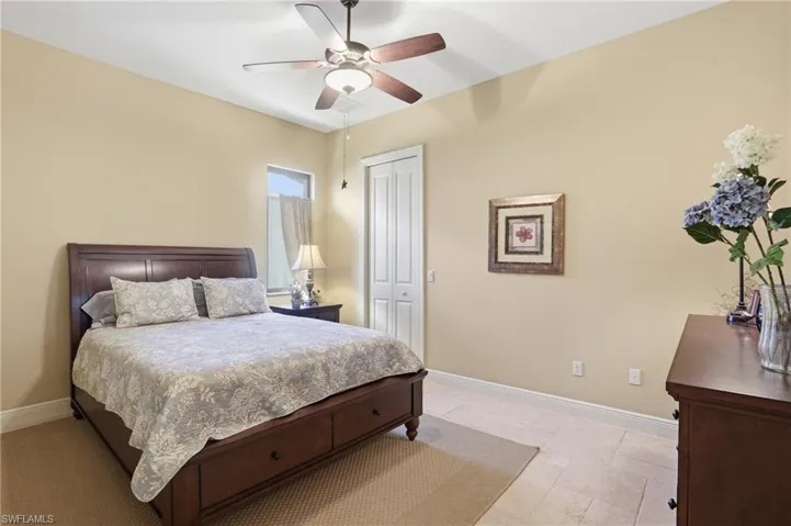 Bedroom featuring a ceiling fan and a closet