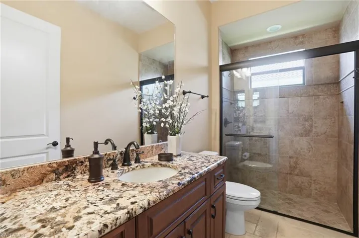 Full bath with vanity and a stall shower