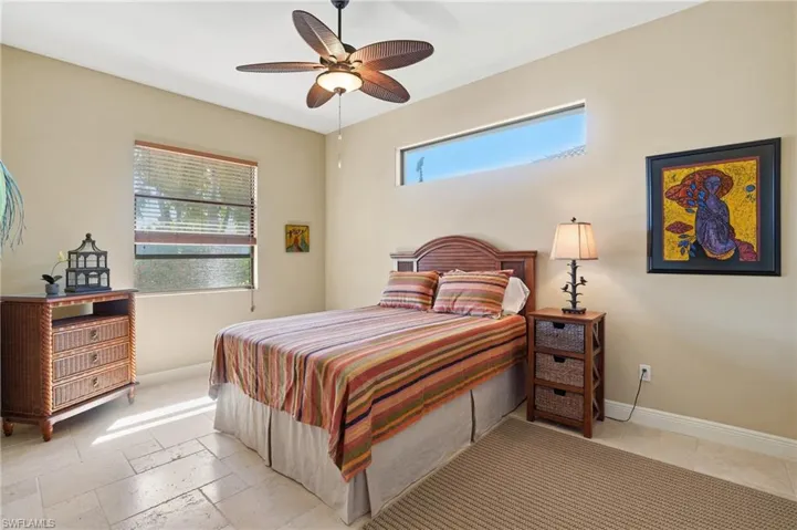 Bedroom featuring stone tile flooring and ceiling fan