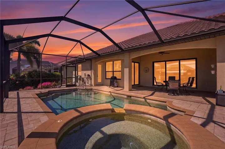 Combined pool / hot tub with a patio, a lanai, a sunroom, and outdoor dining area