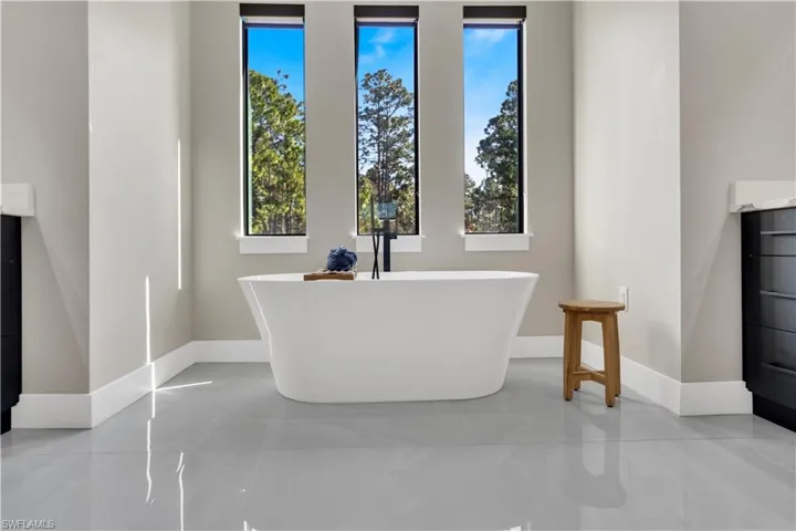 Full bath with vanity and a soaking tub