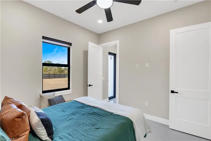 Bedroom featuring ceiling fan, recessed lighting, and light tile patterned floors