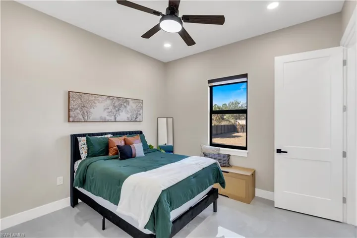 Bedroom with a ceiling fan and recessed lighting