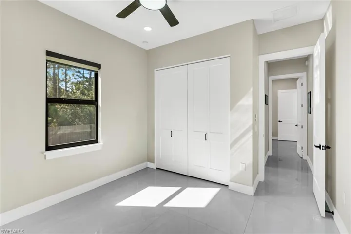 Unfurnished bedroom featuring a ceiling fan and a closet