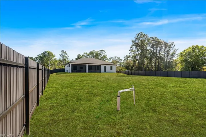 Fenced backyard with a sunroom