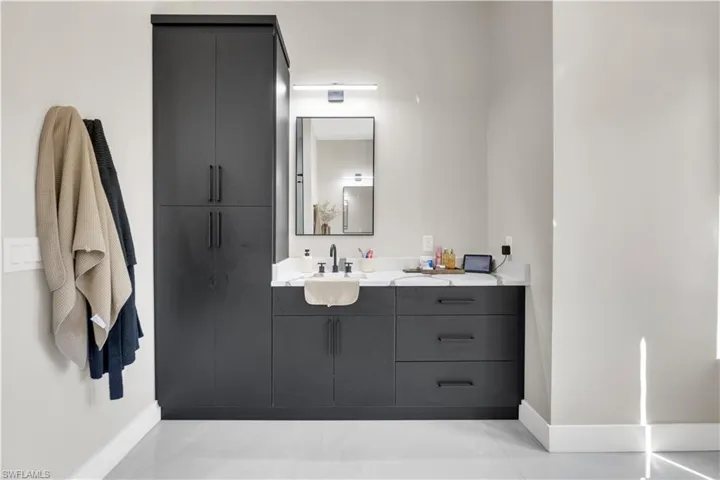 Bathroom with vanity and baseboards