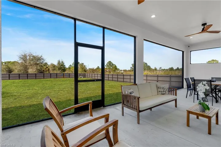 Sunroom with a ceiling fan and outdoor lounge area