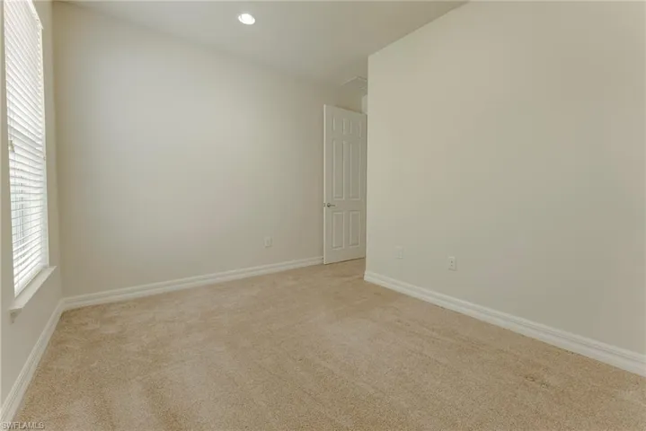 Unfurnished room with light carpet