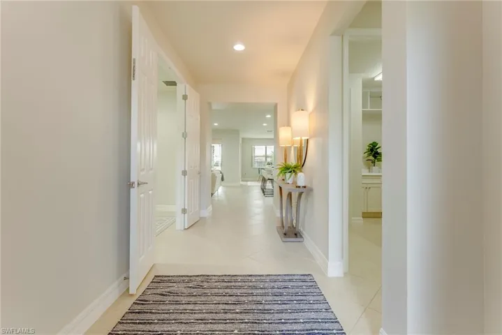 Corridor with light tile patterned floors