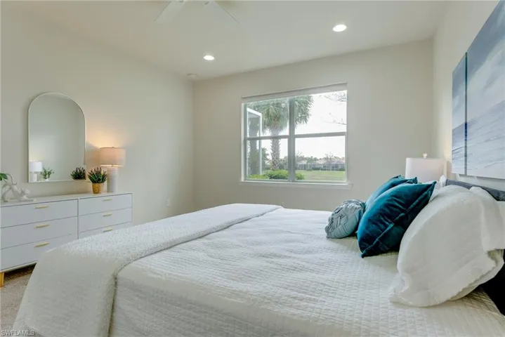 Carpeted bedroom with ceiling fan