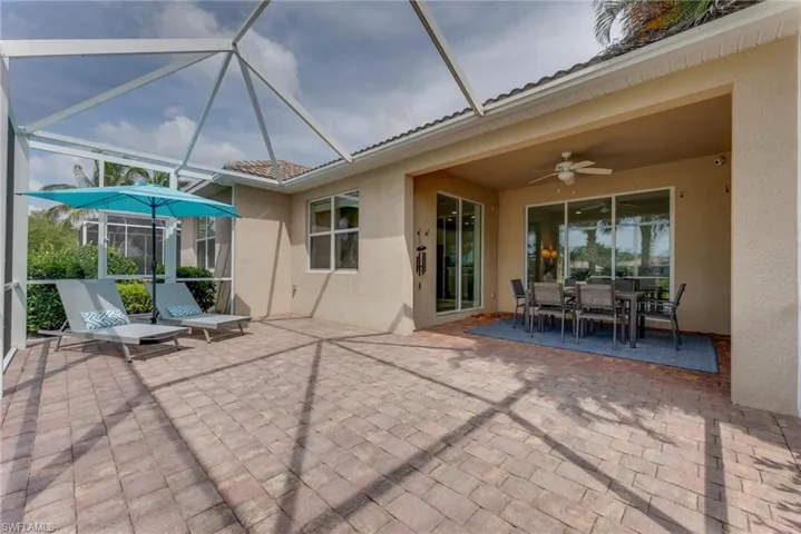 View of patio with glass enclosure and ceiling fan