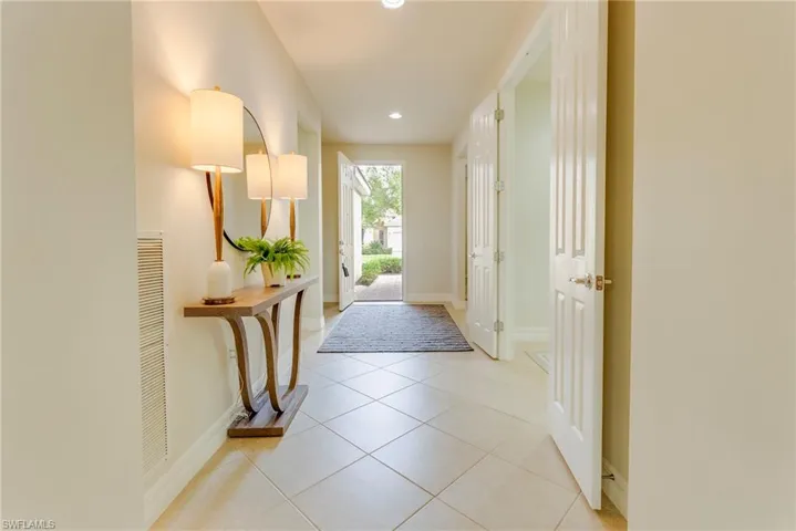 Corridor featuring light tile patterned floors