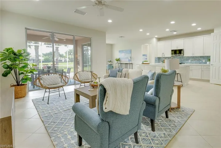 Living room featuring ceiling fan and light tile patterned floors