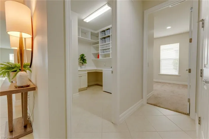 Corridor with light tile patterned flooring