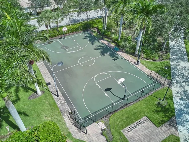 View of basketball court featuring a yard